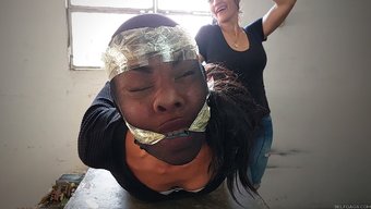 Young Girl Caught In Bondage By Big Boobed Latinas